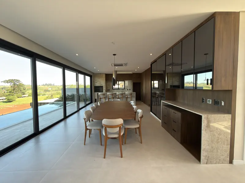 Jantar e cozinha com vidro do piso ao teto voltado para o campo